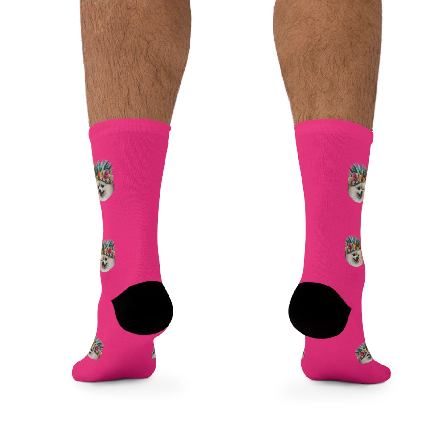 A pair of vibrant pink novelty socks featuring a cheerful Pomeranian in a tropical paradise.