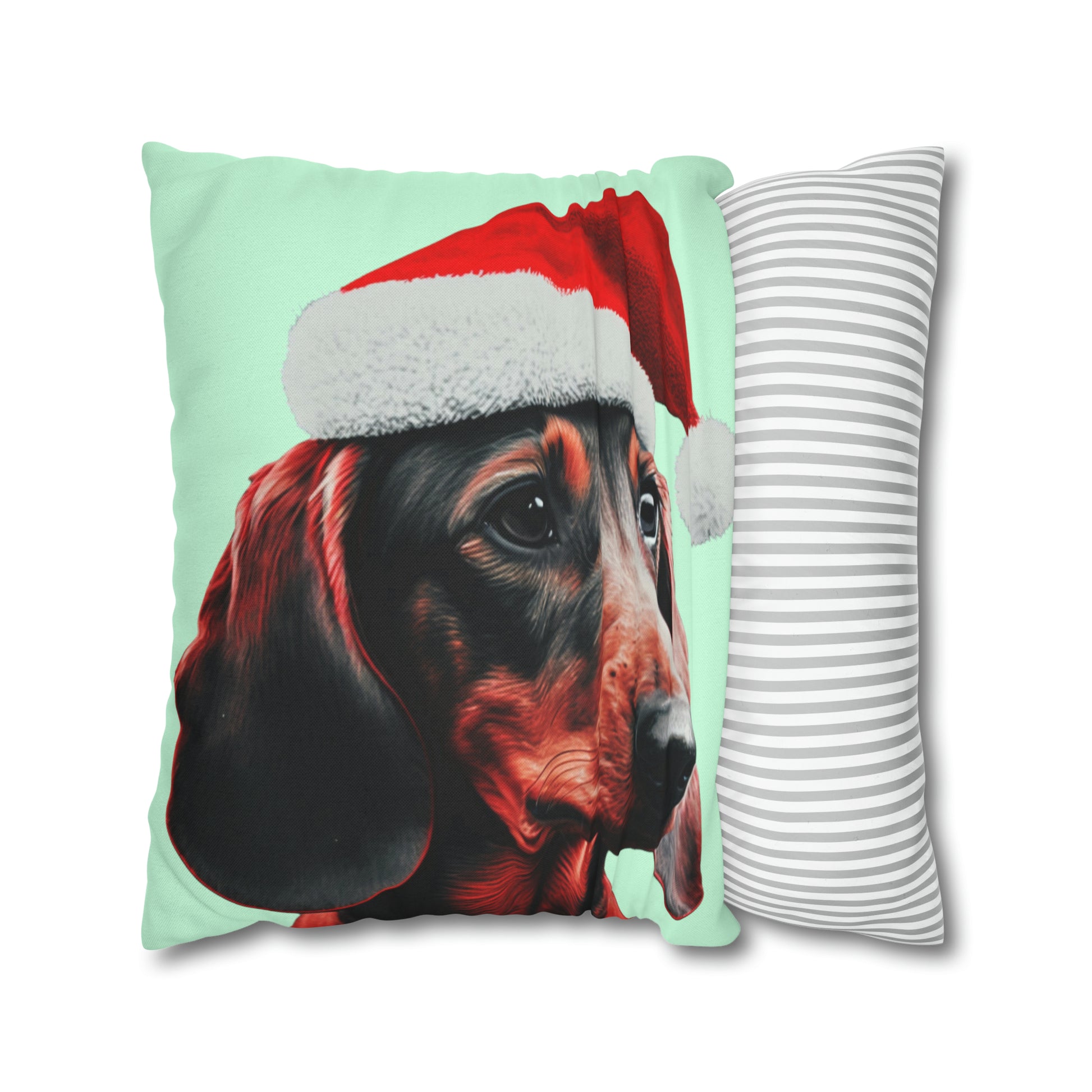 A cushion cover depicting a cute Dachshund wearing a Christmas hat, set against a calming mint green pastel background for a festive and adorable look.