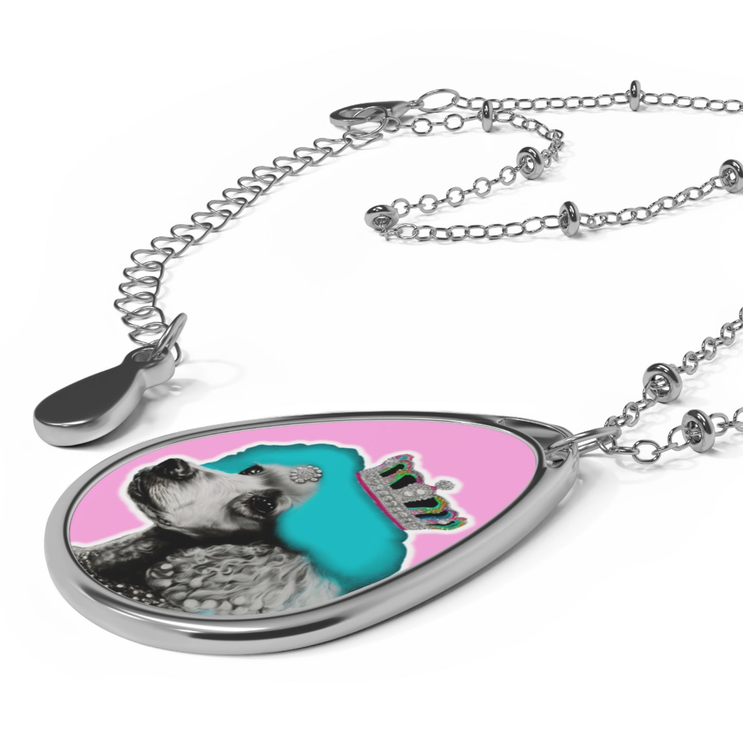 The 'Pop Art Crowned Poodle Oval Pendant Necklace' features a vibrant and colorful design of a regal poodle in pop art style, set within an elegant oval pendant. This unique and stylish piece combines artistic flair with a love for dogs, making it an ideal accessory for fashion-forward pet enthusiasts.