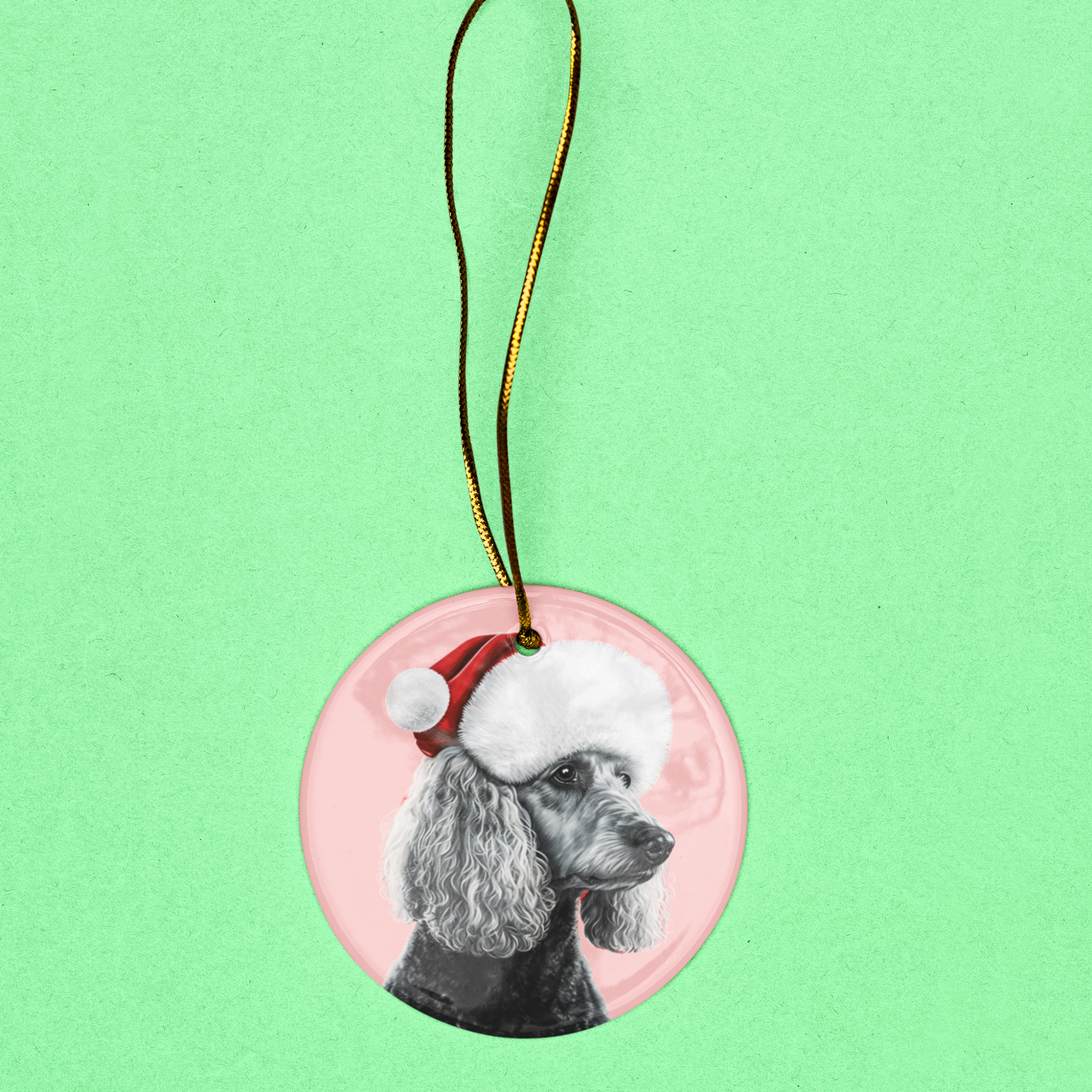 A heart or circle-shaped Christmas ornament featuring an elegant black and white poodle on a soft pastel pink background, perfect for a sophisticated holiday touch.