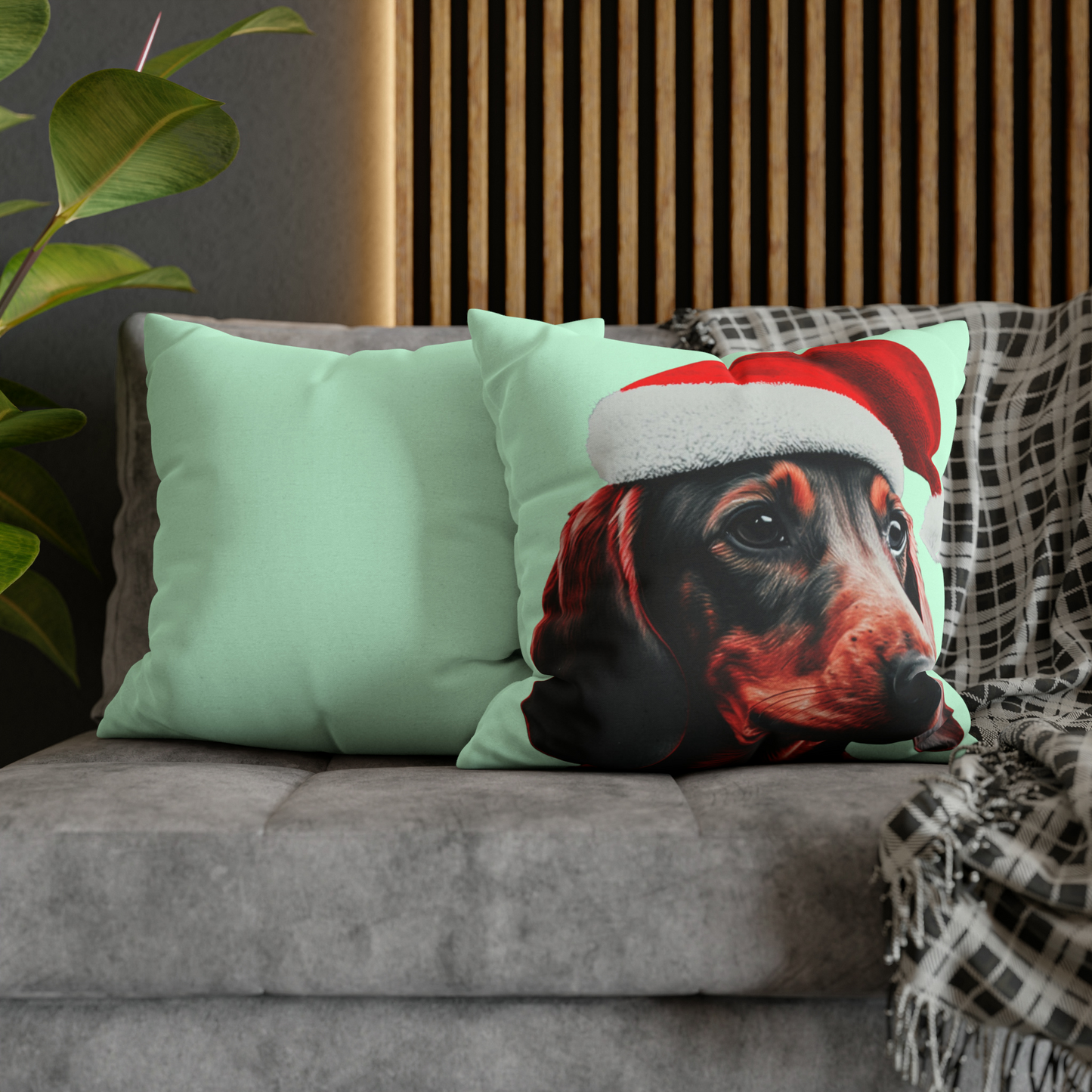 A cushion cover depicting a cute Dachshund wearing a Christmas hat, set against a calming mint green pastel background for a festive and adorable look.