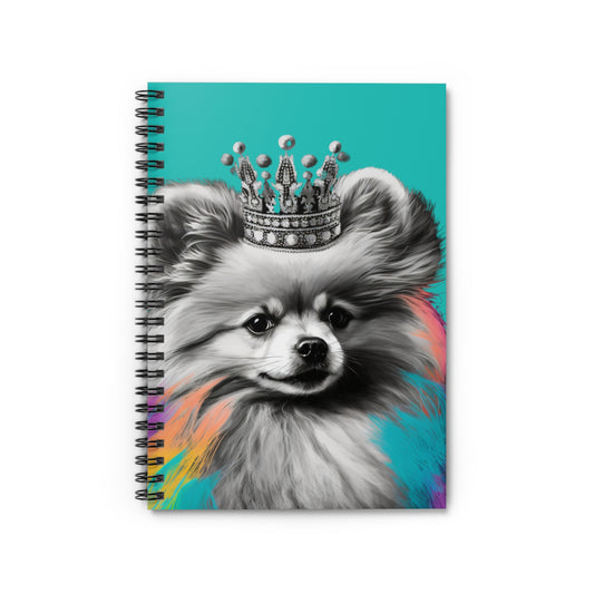 A notebook cover artfully depicting a black and white Pomeranian with splashes of color against a serene blue background, blending monochrome charm with vibrant accents