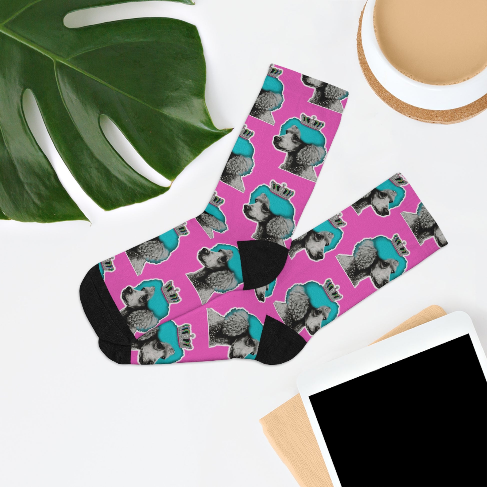 Pair of fashionable socks featuring a pop art design of poodles against a pink background, embodying a chic and playful canine fashion statement.