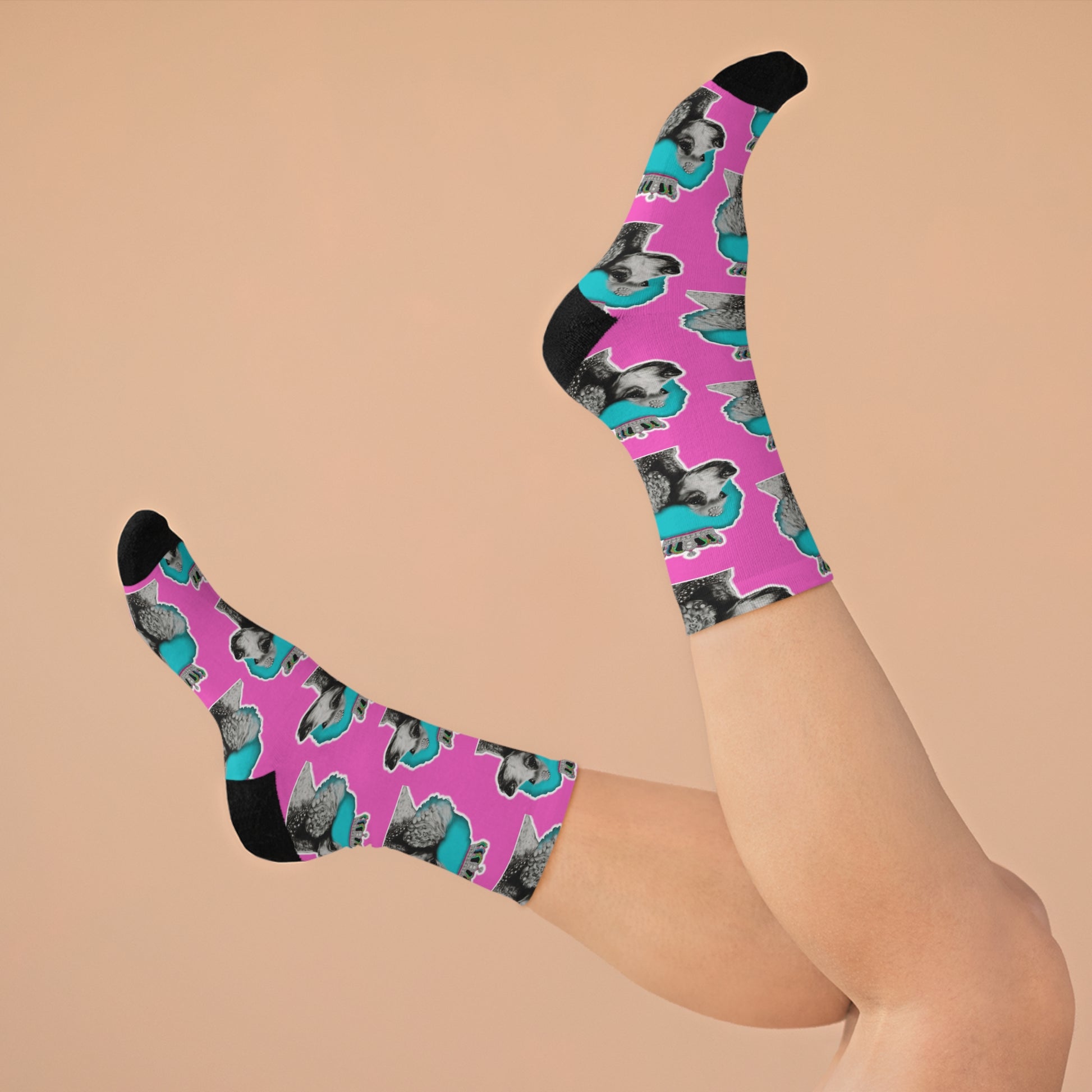 Pair of fashionable socks featuring a pop art design of poodles against a pink background, embodying a chic and playful canine fashion statement.